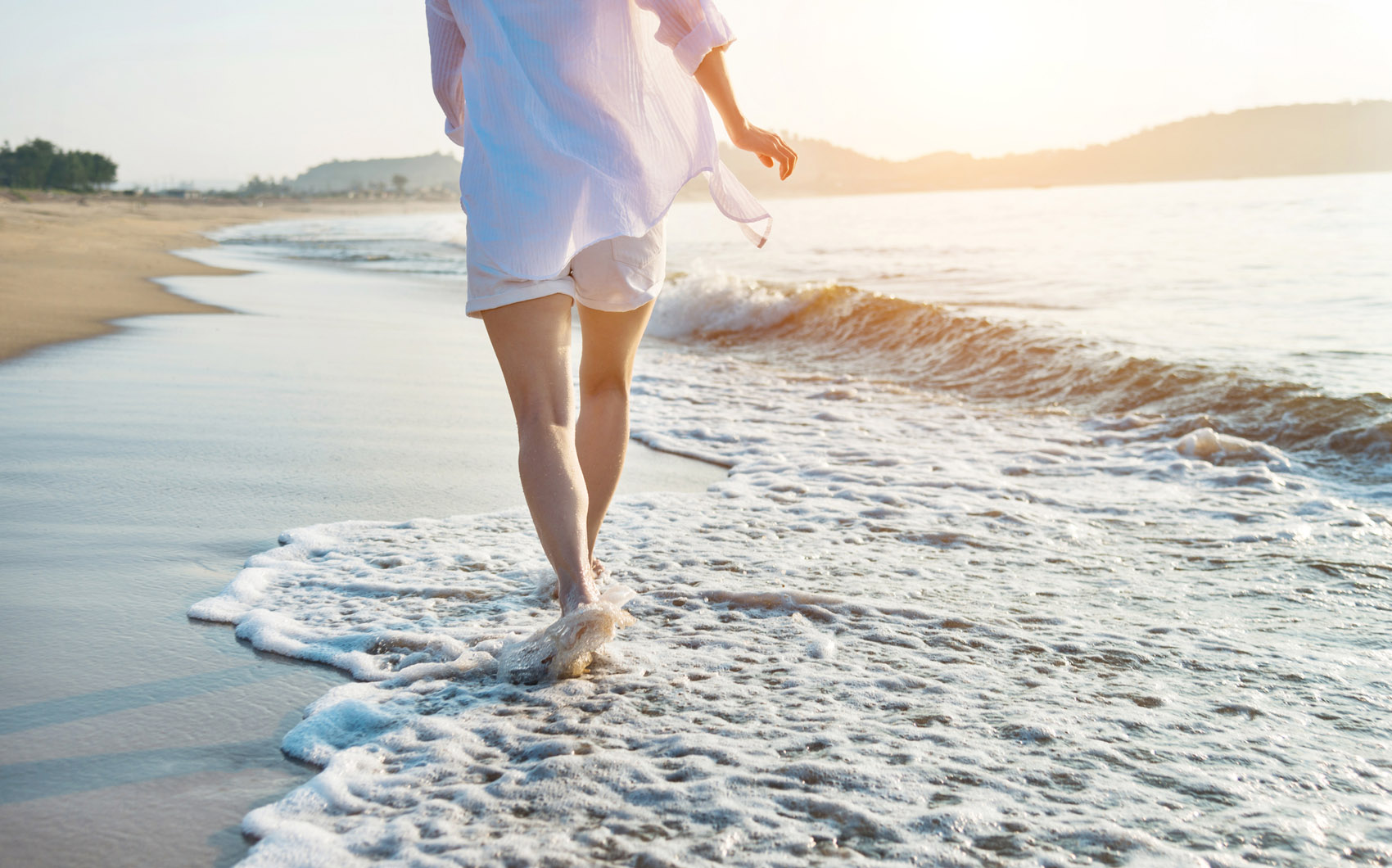 Woman leg walking on beach.